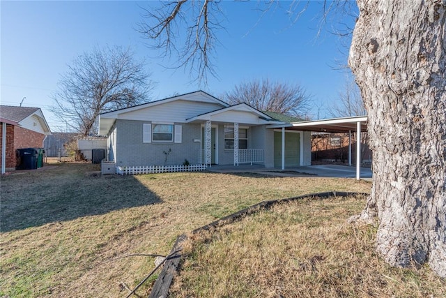 ranch-style house featuring a carport, covered porch, and a front lawn