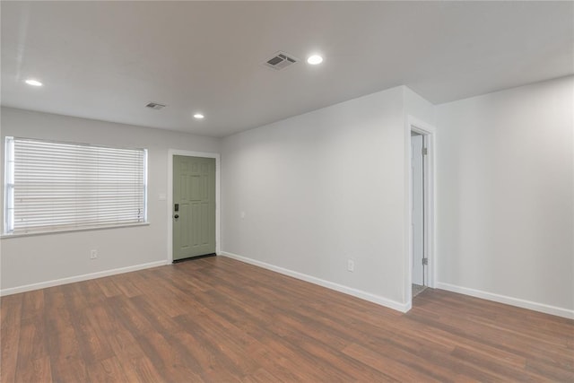 spare room with dark hardwood / wood-style flooring