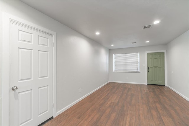 unfurnished room featuring dark wood-type flooring