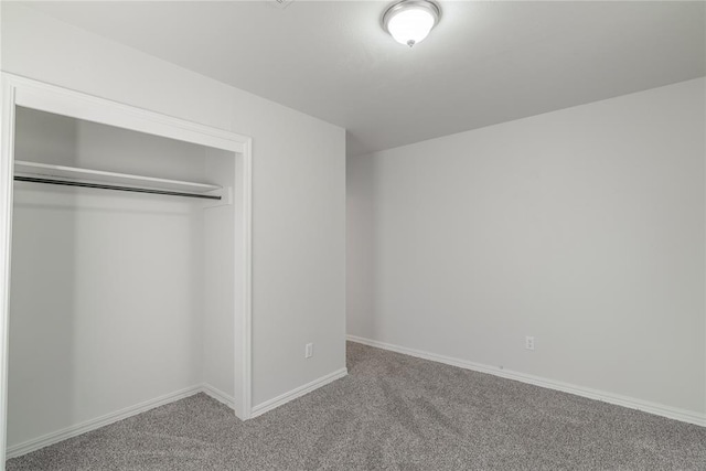 unfurnished bedroom featuring a closet and carpet floors