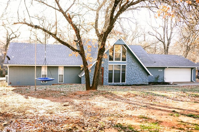 back of house featuring a garage