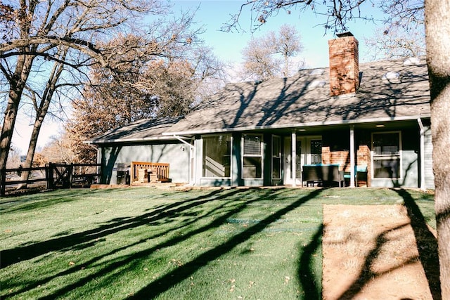 back of house featuring a yard