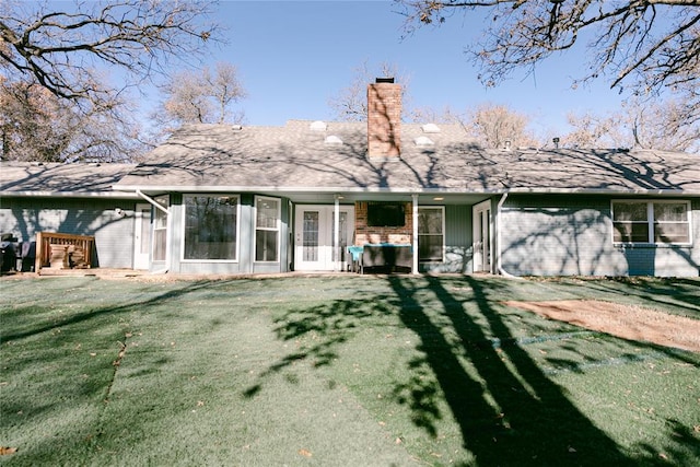 rear view of property with a yard