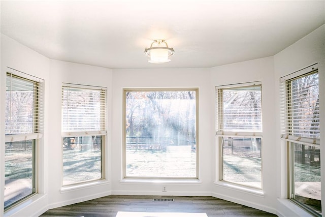 unfurnished dining area featuring hardwood / wood-style floors