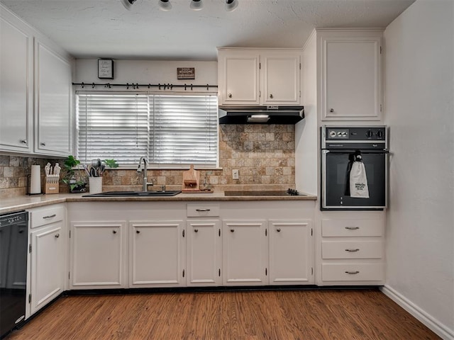 kitchen with hardwood / wood-style flooring, sink, white cabinets, and black appliances