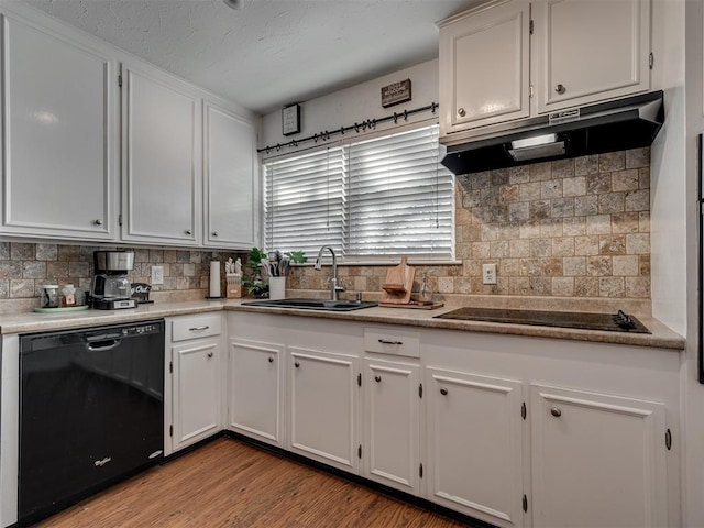 kitchen featuring sink, white cabinets, decorative backsplash, light hardwood / wood-style floors, and black appliances