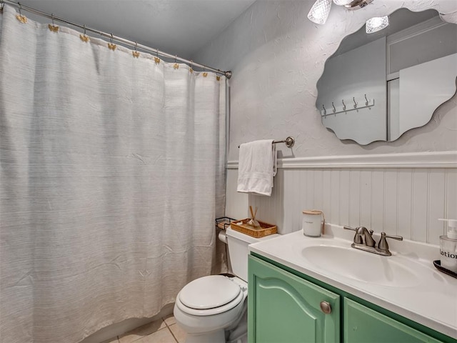 bathroom with vanity, toilet, and tile patterned flooring