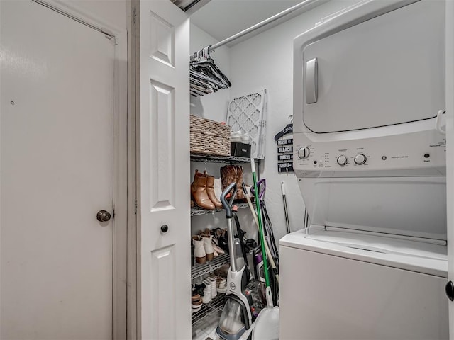 laundry room with stacked washing maching and dryer