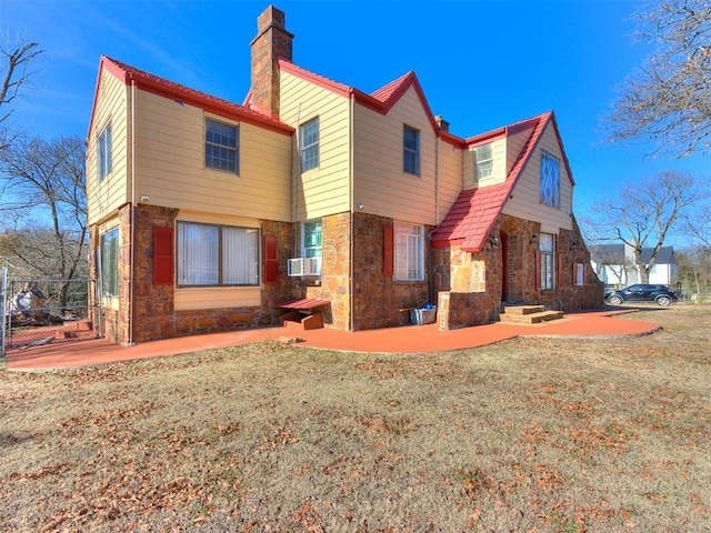 back of property with a lawn, cooling unit, and a patio