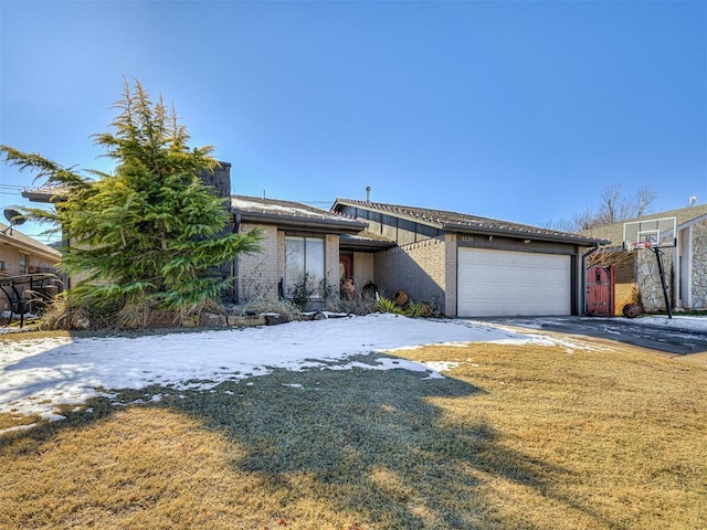 view of front of house with a garage and a front lawn