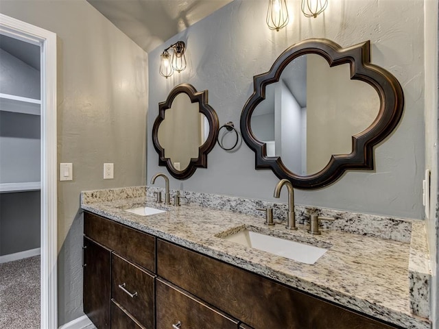 bathroom with vanity and vaulted ceiling