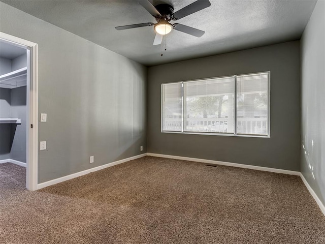 spare room featuring carpet and ceiling fan