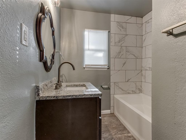 bathroom featuring vanity and tiled shower / bath combo