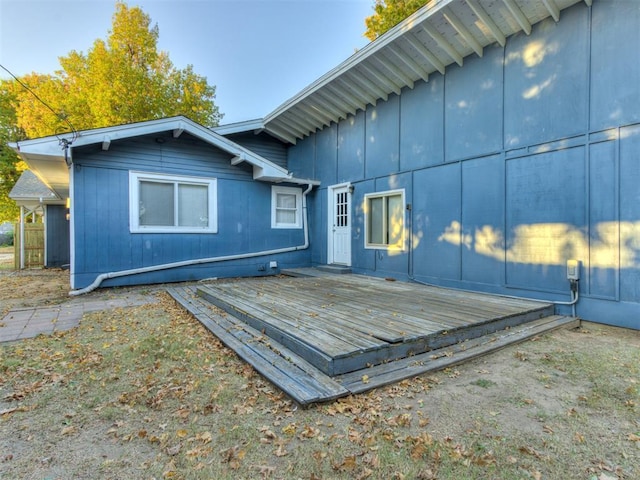 back of house featuring a wooden deck