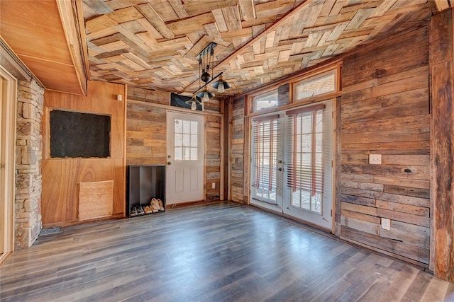 unfurnished room featuring dark hardwood / wood-style floors, wood walls, wooden ceiling, and french doors