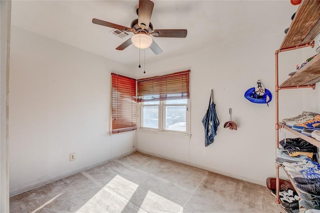 empty room with light carpet and ceiling fan