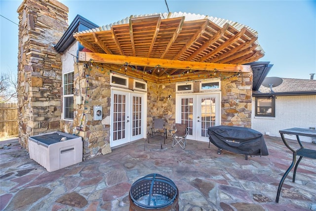 view of patio featuring french doors and an outdoor fire pit