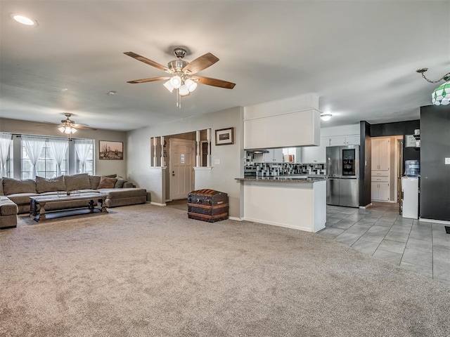 living room featuring light carpet and ceiling fan