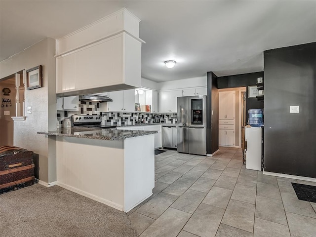 kitchen featuring kitchen peninsula, white cabinetry, stainless steel appliances, and ventilation hood