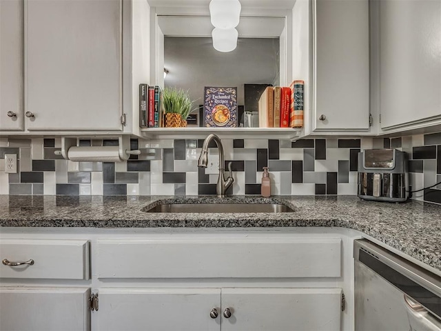 kitchen with backsplash, white cabinetry, sink, and dishwasher