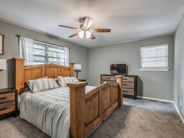 carpeted bedroom featuring multiple windows, ceiling fan, and crown molding