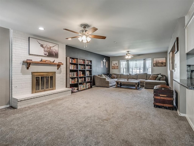 carpeted living room featuring ceiling fan and a fireplace