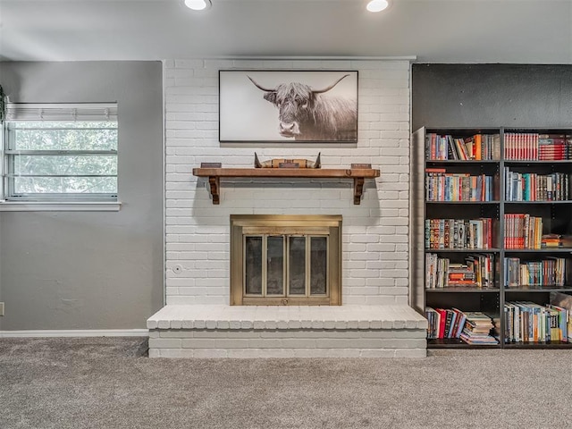 interior space with a fireplace and carpet floors