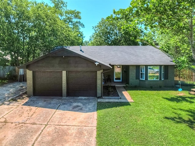 ranch-style house featuring a front yard and a garage