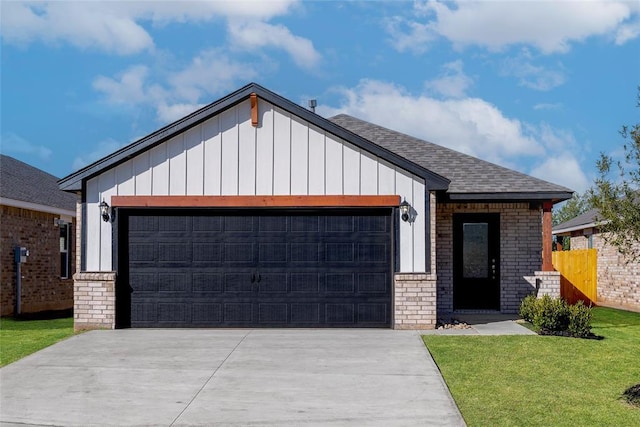 view of front of property with a front yard and a garage