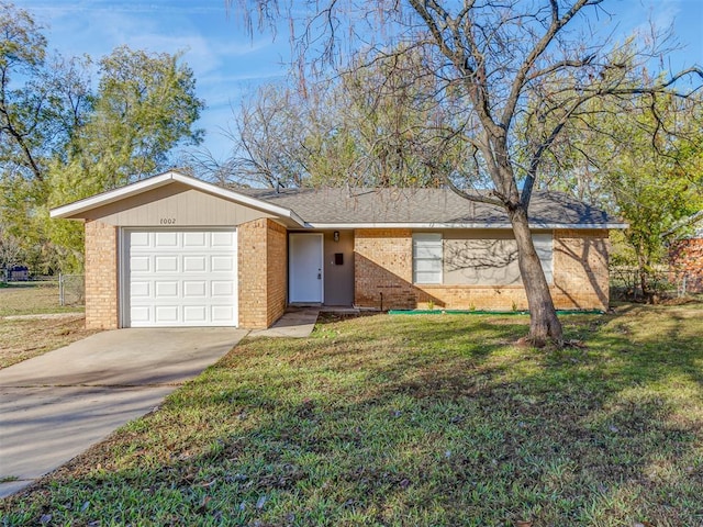 single story home with a garage and a front lawn