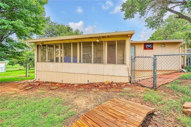 view of home's exterior with a sunroom