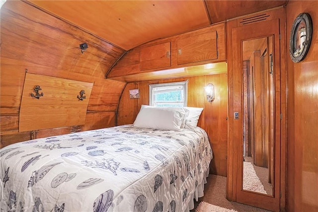 bedroom with wood walls, carpet floors, and wood ceiling