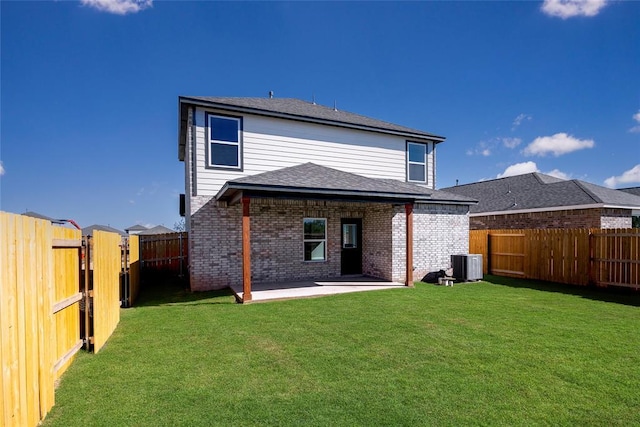 back of property with a yard, a patio, and central air condition unit