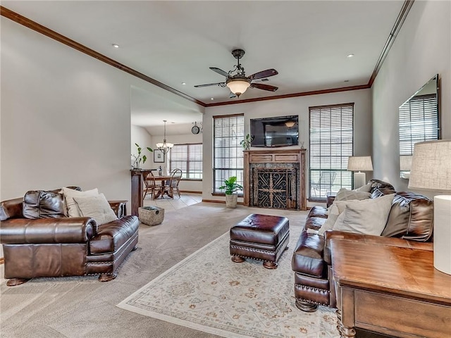 carpeted living room featuring ceiling fan with notable chandelier and ornamental molding