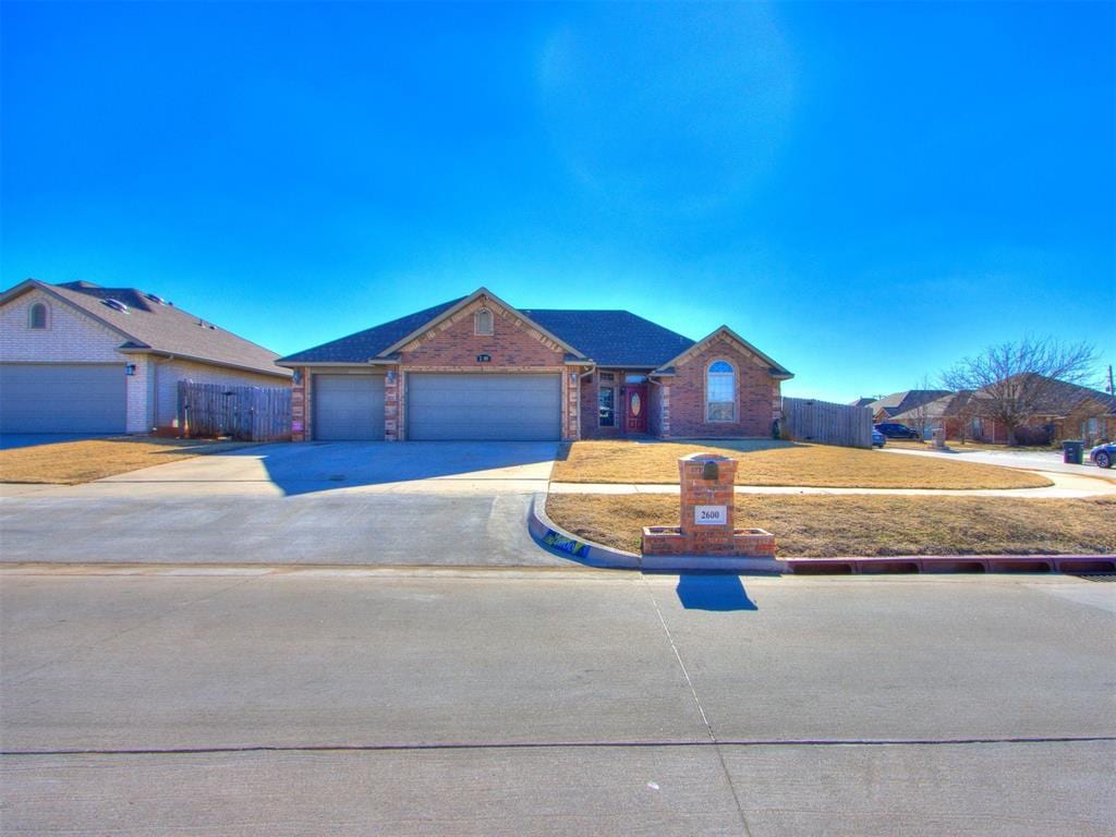 ranch-style home with a garage and a front yard