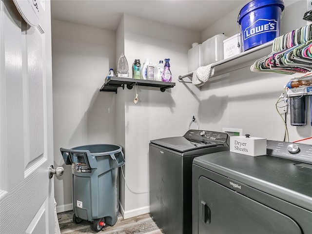 laundry room featuring hardwood / wood-style floors and washing machine and dryer