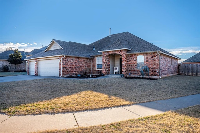 view of front of house featuring a garage and a front lawn