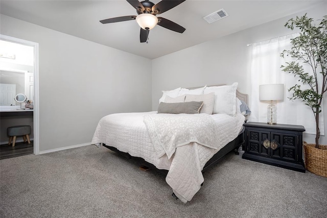 bedroom with carpet, ceiling fan, and connected bathroom