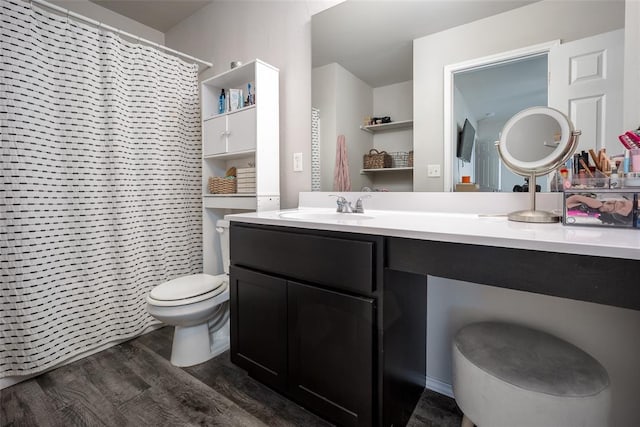 bathroom with vanity, wood-type flooring, and toilet