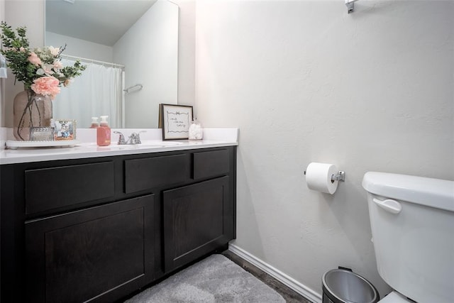 bathroom featuring vanity and toilet