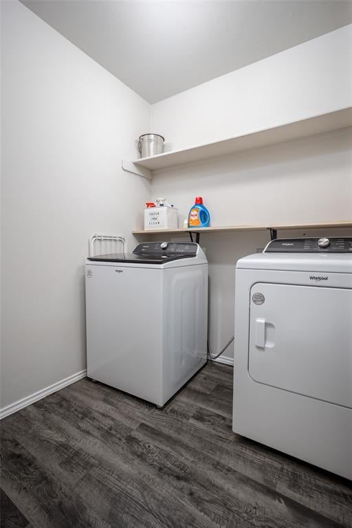 laundry area featuring washing machine and clothes dryer and dark wood-type flooring