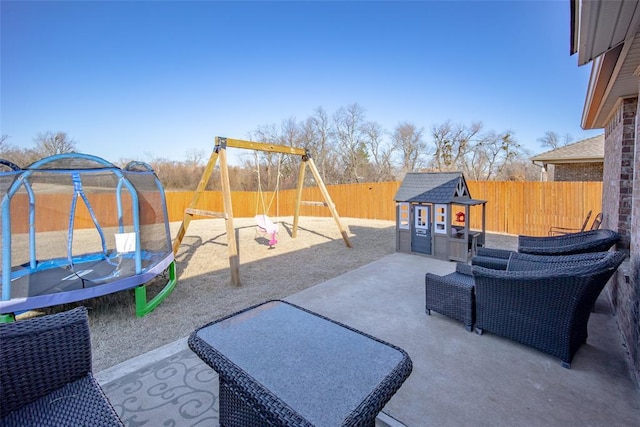 view of patio / terrace with a trampoline and a playground