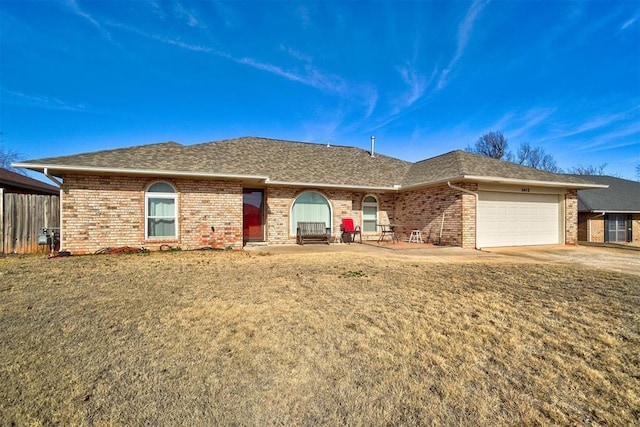 single story home with a garage and a front yard