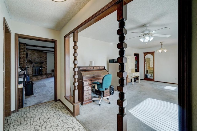 hall with light carpet and a textured ceiling