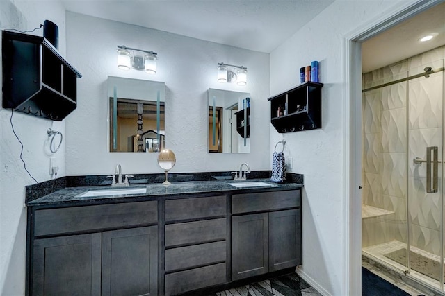 bathroom featuring vanity and an enclosed shower