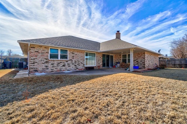 back of property with a yard, central AC, and a patio