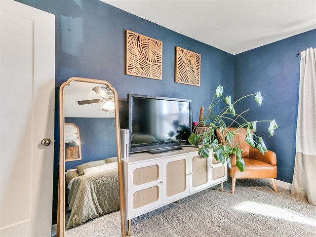 interior space with ceiling fan and carpet floors