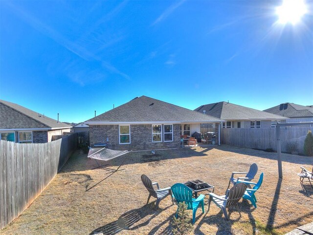 back of property featuring a fire pit