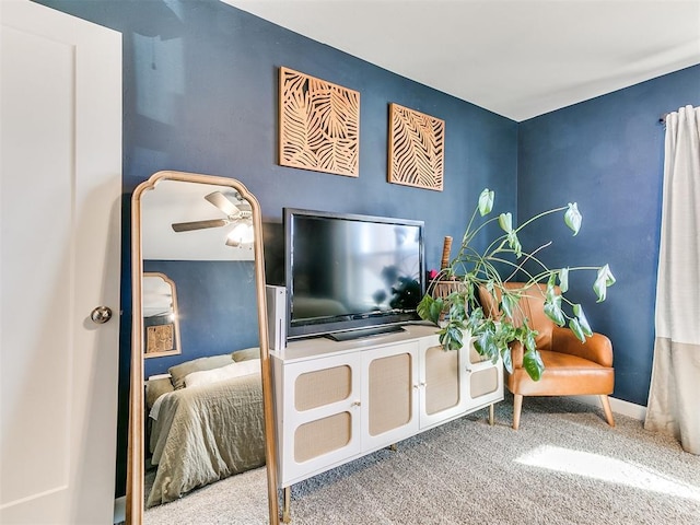 interior space with carpet and ceiling fan