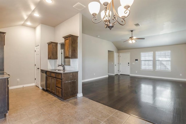 kitchen with ceiling fan with notable chandelier, decorative light fixtures, dishwasher, lofted ceiling, and sink